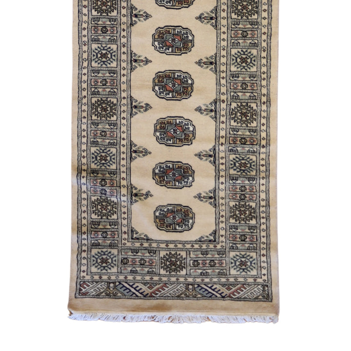 2'7" x 9'4" GOLD AND IVORY BOKARA GEOMETRIC PAKISTANI RUG